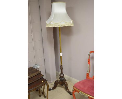 A brass stemmed standard lamp on Victorian carved mahogany base, fitted silk shade.