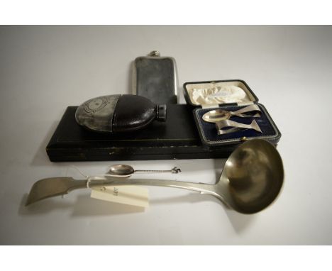 Metalware, to include: a silver nursing set; a ladle; hip flasks; an Isle of Man spoon; and a pair of cased fish servers. (6)