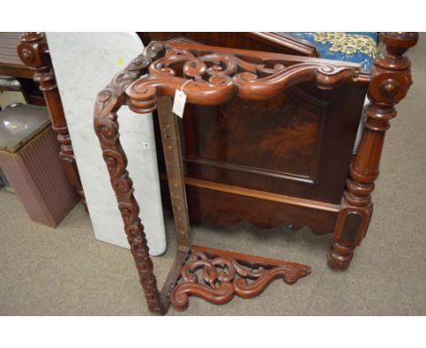 A Victorian mahogany wall mounted console table, the soft grey/white grained marble shaped top on a scroll carved and pierced