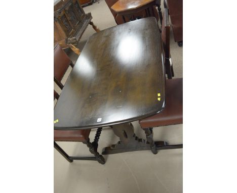 A dark stained Ercol dining table.