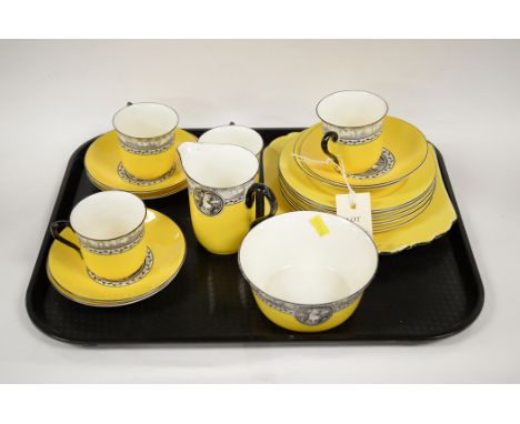 A Shelley part tea service, to include: teacups, saucers, cream jug, sugar bowl, side plates and a sandwich plate, on yellow 