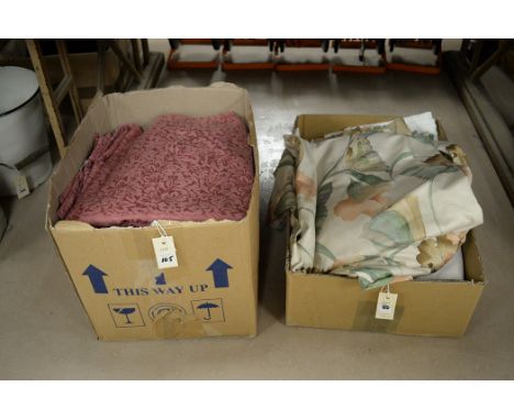 Two boxes containing curtains and material.