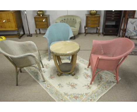 A Lloyd Loom table; and three chairs.