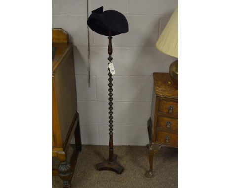 A bobbin turned mahogany wig stand, 20cms high.