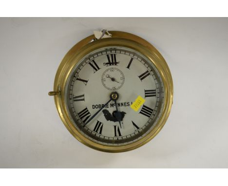A brass ship's chronometer by Dobbie McInnes Ltd., with enamel roman numeral dial and subsidiary seconds aperture.