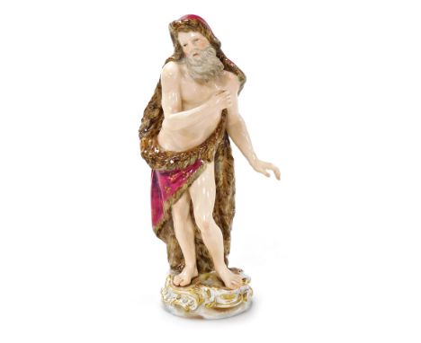 A Meissen porcelain figure, modelled as the allegorical Season of Winter, modelled as a bearded man wearing a fur cloak, lack