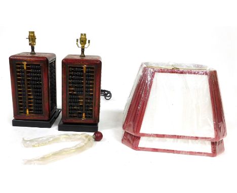 A pair of Chinese simulated red lacquer abacus square section table lamps, the bases measuring 32cm high, with red and white 