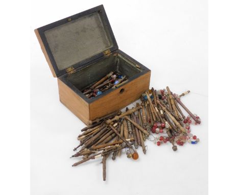 A Victorian mahogany and marquetry inlaid box, the hinged lid enclosing a quantity of lace bobbins with beads, the caddy 17cm