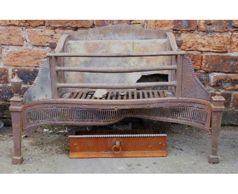 A polished steel and cast iron fire grate, with tapering finials, shaped beaded brackets and pierced base, on square tapering