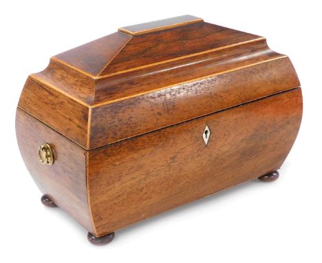 A Regency rosewood and boxwood strung sarcophagus shaped tea caddy, the hinged lid enclosing fitted interior with two lidded 