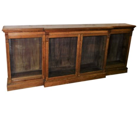 A Victorian light oak breakfront bookcase, with moulded cornice, and four glazed doors, on a plinth base, 116cm high, 277cm w