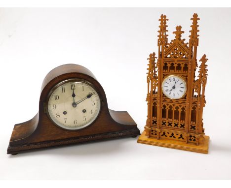 A wooden cased cathedral mantel clock, with pierced and arched tracery, the circular dial bearing Roman numerals, quartz move