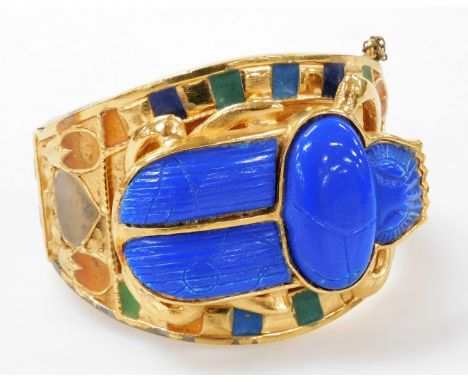 A late 20thC Egyptian revival scarab bangle, by Thomas Fattorini Limited, with an imitation carved lapis lazuli scarab beetle