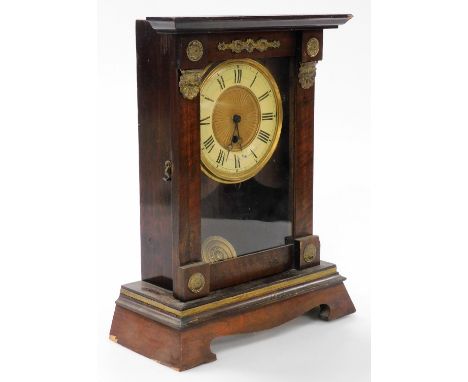 A late 19thC American mahogany cased mantel clock, circular brass dial with chapter ring bearing Roman numerals, thirty hour 