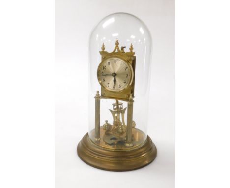 A German brass cased four hundred day anniversary clock, with silvered dial bearing Arabic numerals, on a brass base, with gl