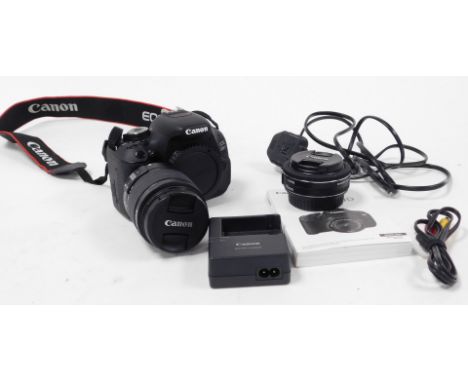 A Canon EOS 600D DSLR camera, together with battery charger, instruction manual, strap, and an EF-S 18-55mm lens, and a macro