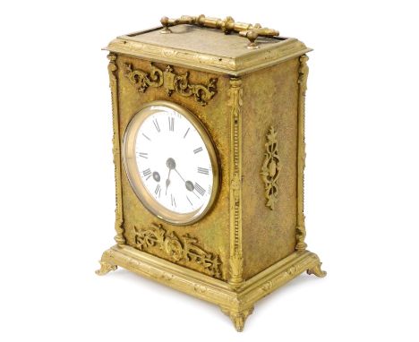 A late 19thC gilt cased mantel clock, with eight day striking movement, having white enamel dial and Roman numerals, the case