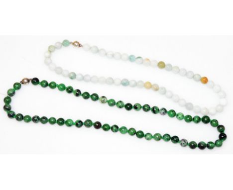 A zoisite and ruby bead necklet, the beads of uniform form, on a white metal magnetic clasp, 49cm wide, together with a jade 