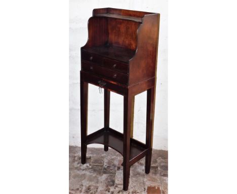 A late Georgian mahogany side cabinet, the galleried top with a shaped shelf above a recess, with an arrangement of two short