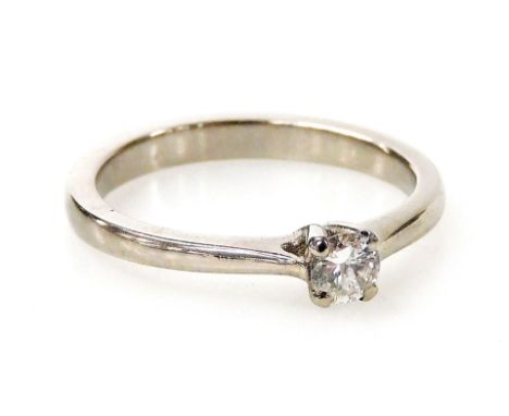 A palladium and diamond solitaire ring, with a round brilliant cut diamond totalling 0.19ct, in a four claw setting, ring siz
