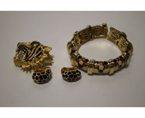 A BUTLER &amp; WILSON TIGER'S HEAD BROOCH TOGETHER WITH A BANGLE AND A PAIR OF CLIP ON EARRINGS