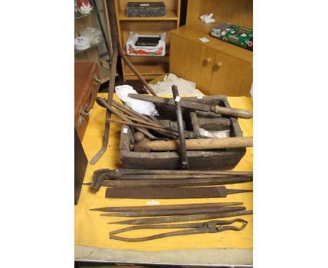 AN ANTIQUE BLACKSMITH TOOL OUTFIT TO INCLUDE A VINTAGE WOODEN TRUGG, FILES, TONGS ETC.