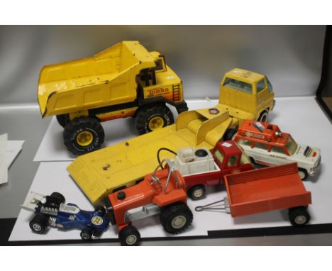 FOUR TONKA TOYS INCLUDING AIR FRANCE RESCUE TRUCK, RACING CAR, MIGHTY DUMP TRUCK ETC. TOGETHER WITH A YELLOW ARTICULATED LORR