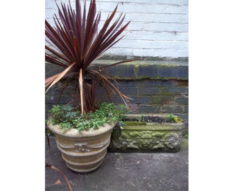 A RECONSTITUTED STONE PLANTER TROUGH AND A LARGE PLANTER