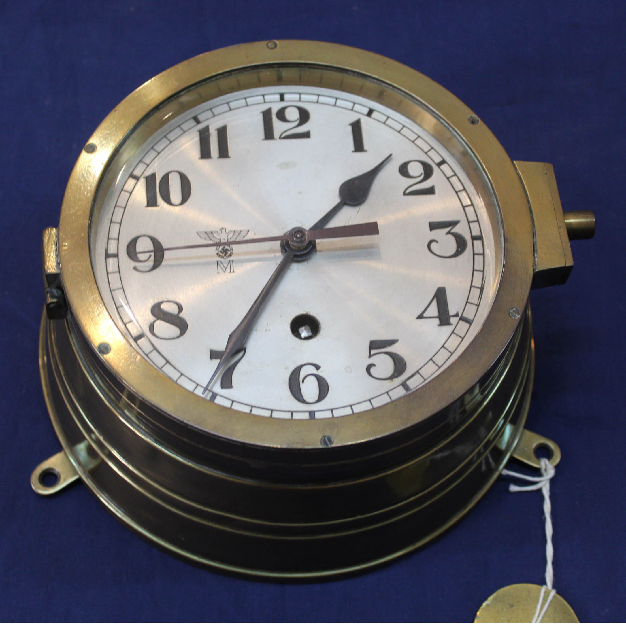 A Third Reich era Kriegsmarine bulkhead clock in brass case, the ...