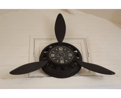 A retro clock in the form of an 'aeroplanes engine' with propellers (battery movement)