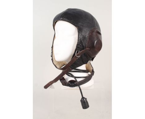 A German WWII era Luftwaffe leather flying helmet, fleece lined with leather covered earphones and integral throat microphone