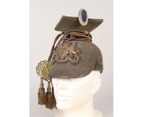A WWI era Bavarian Lancers green felt helmet complete with gilt plate, cockades and languettes, makers label also in place