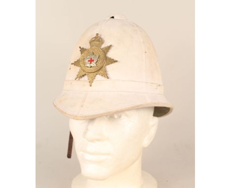 A Canadian Colonial helmet with militia plate bearing maple leaf with red cross