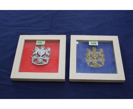 Two helmet plates framed and glazed, a Royal Artillery example with a replica