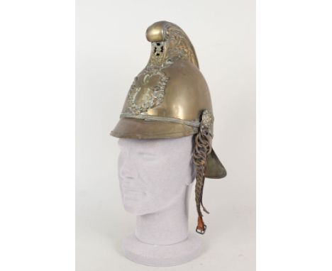 An Edwardian brass Merryweather firemans helmet, badged to C.F.B. (Chatham Fire Brigade) complete with liner and chin scales 