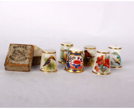 An early c20th boxed Royal Worcester thimble hand painted with a kookabura together with 5 other Royal Worcester thimbles  