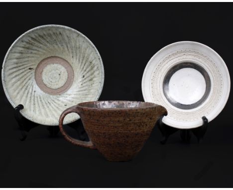 A collection of studio pottery to include a temoko glazed bowl with stamp to base, a celadon glazed bowl in the style of Davi