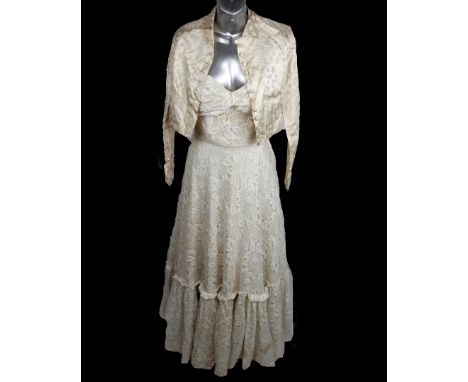 A 1900's sleeveless boned wedding dress with a full lace bodice sweet heart neckline with matching short sleeved jacket, toge