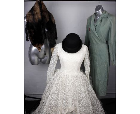 A cream wedding dress with hoop skirt, together with cream fur shawl, a WVS Ritchwear green dress size 44, Cromaco hospital a