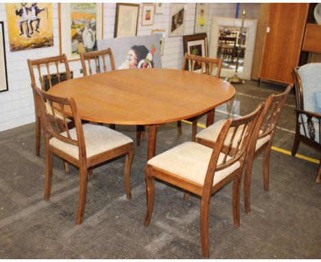 A 1960's teak  circular extending dining table with intergral butterfly leaf &amp; a set of five modern stained beech ladder 