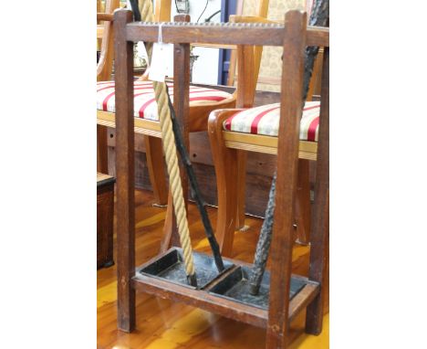 An oak four division stick/umbrella stand with lead drip trays together with a single walking stick, 67cm(h)
