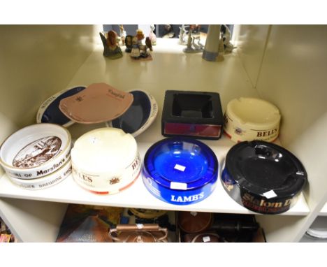 An assorted collection of ten vintage pub ashtrays, including Slalom D, Bell's Old Scotch Whisky, Dunhill, and Martell