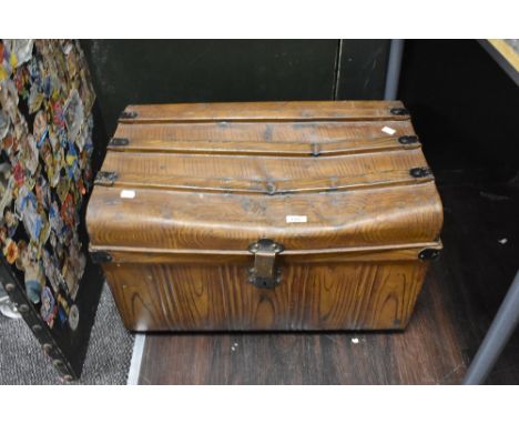 A vintage tin trunk having scumbled finish.