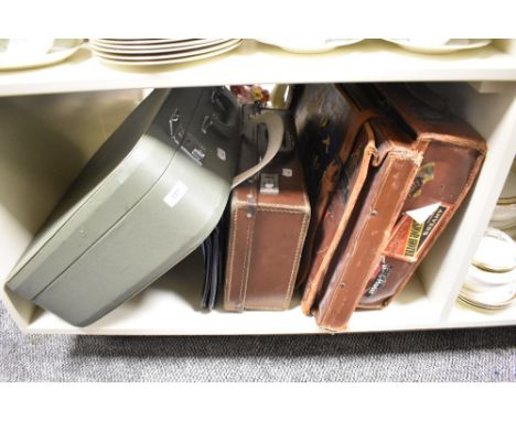 Two vintage brown leather suitcases, a leather fashion handbag, and a hardshell vintage suitcase