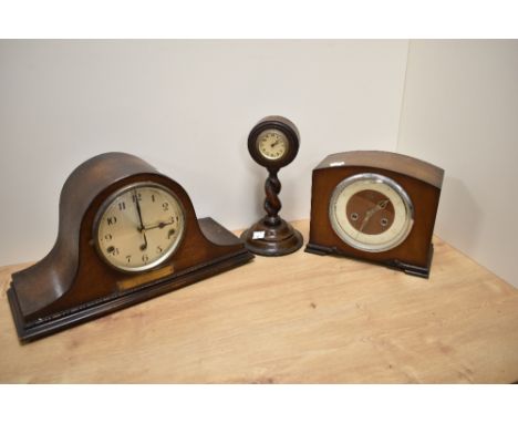 An early 20th Century oak cased mantel clock, of Napoleon's Hat shape, having a silvered arabic dial, three train movement, a