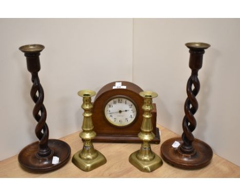 An Edwardian mahogany inlaid mantel clock, of domed form, having an enamelled arabic dial, eight day movement, and raised upo