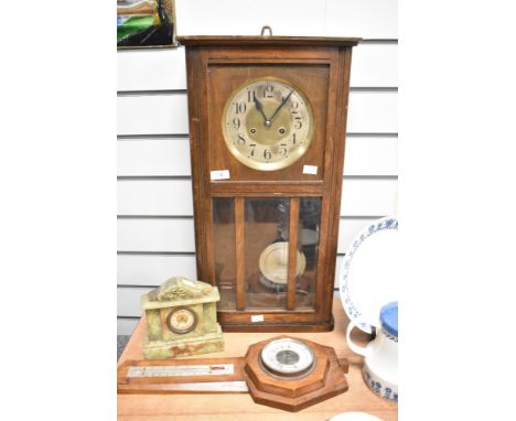 An early 20th century oak cased wall clock, an onyx mantel clock and a barometer.