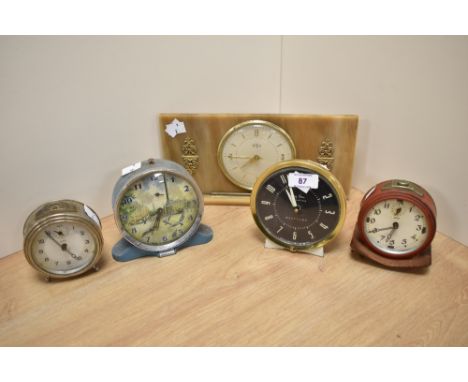 Four mid century alarm clocks and a Tempora mantel clock with celluloid surround.