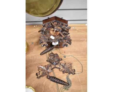 A vintage German Black Forest style cuckoo clock with acorn weights