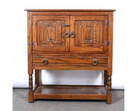 Reproduction oak cupboard, linen-fold panelled doors over a drawer, turned legs joined by a shelf, width 79cm, depth 41cm, he